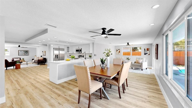 829 Riverside Dr, Tarpon Springs, FL 34689 - dining space with a ceiling fan, light wood finished floors, a textured ceiling, plenty of natural light, and recessed lighting