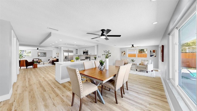 829 Riverside Dr, Tarpon Springs, FL 34689 - dining room featuring a ceiling fan, light wood-type flooring, a textured ceiling, plenty of natural light, and recessed lighting