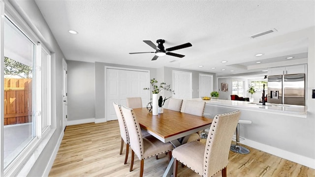 829 Riverside Dr, Tarpon Springs, FL 34689 - dining area with light wood finished floors, baseboards, a textured ceiling, a ceiling fan, and recessed lighting