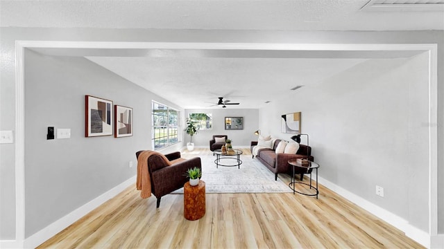 829 Riverside Dr, Tarpon Springs, FL 34689 - living area featuring light wood-type flooring, ceiling fan, baseboards, and a textured ceiling
