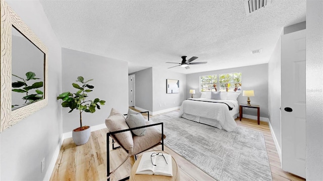 829 Riverside Dr, Tarpon Springs, FL 34689 - bedroom featuring light wood-style floors, a textured ceiling, baseboards, and a ceiling fan