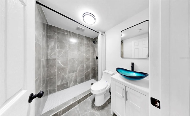 829 Riverside Dr, Tarpon Springs, FL 34689 - bathroom with vanity, toilet, and a tile shower