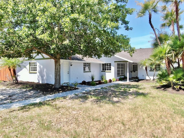 829 Riverside Dr, Tarpon Springs, FL 34689 - single story home with a front lawn, stucco siding, and a shingled roof