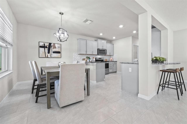 6563 Ryestone Way, Wesley Chapel, FL 33545 - dining area with a chandelier, recessed lighting, baseboards, and light tile patterned flooring