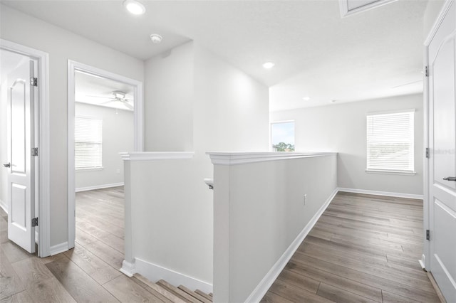 6563 Ryestone Way, Wesley Chapel, FL 33545 - hall with an upstairs landing, wood finished floors, recessed lighting, and baseboards