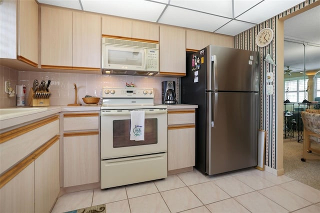 4550 Cove Cir Unit 1003, Saint Petersburg, FL 33708 - kitchen with white appliances, light countertops, tasteful backsplash, and light tile patterned floors