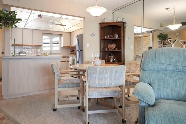 4550 Cove Cir Unit 1003, Saint Petersburg, FL 33708 - dining room featuring ceiling fan and light carpet