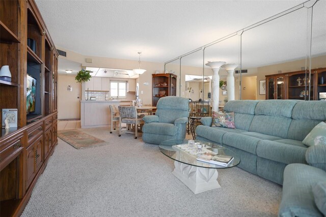4550 Cove Cir Unit 1003, Saint Petersburg, FL 33708 - living area with decorative columns and light colored carpet