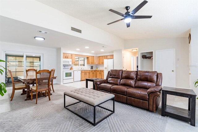 1818 Willow Oak Dr, Palm Harbor, FL 34683 - living room featuring lofted ceiling, ceiling fan, recessed lighting, and light carpet