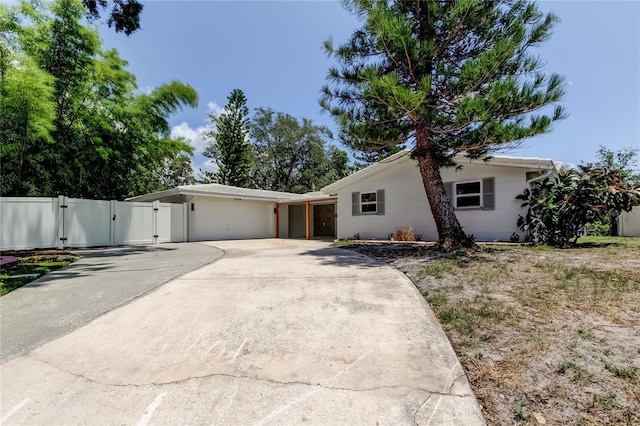10744 Drummond Rd, Tampa, FL 33615 - view of front facade with a gate, a garage, and driveway