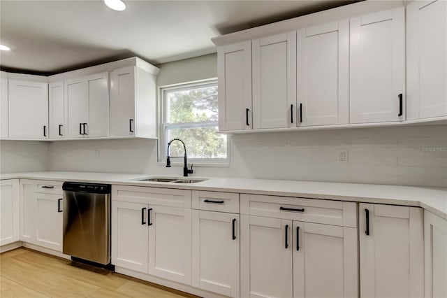 10744 Drummond Rd, Tampa, FL 33615 - kitchen with stainless steel dishwasher, a sink, light countertops, and recessed lighting