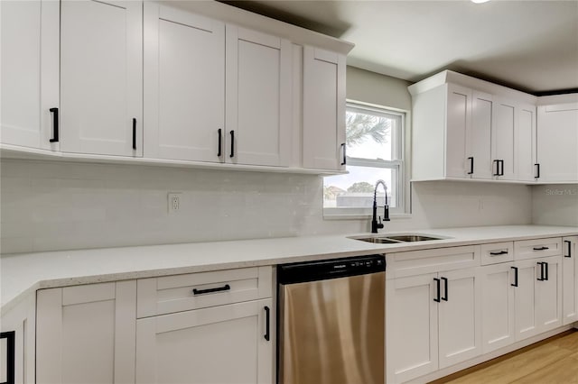 10744 Drummond Rd, Tampa, FL 33615 - kitchen with dishwasher, a sink, tasteful backsplash, white cabinets, and light wood-style floors