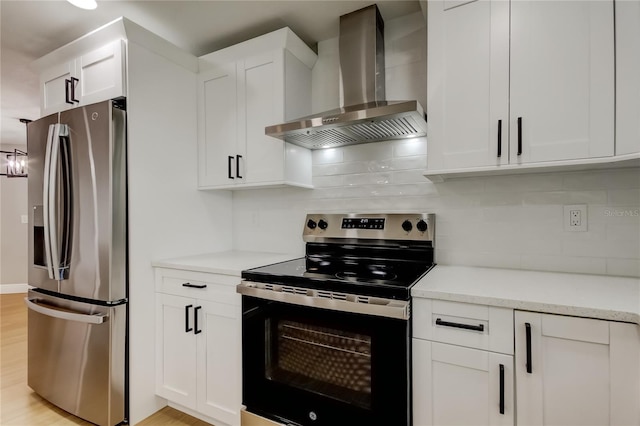 10744 Drummond Rd, Tampa, FL 33615 - kitchen with stainless steel appliances, wall chimney range hood, tasteful backsplash, and white cabinets