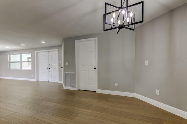 10744 Drummond Rd, Tampa, FL 33615 - unfurnished dining area featuring baseboards, wood finished floors, a chandelier, and recessed lighting