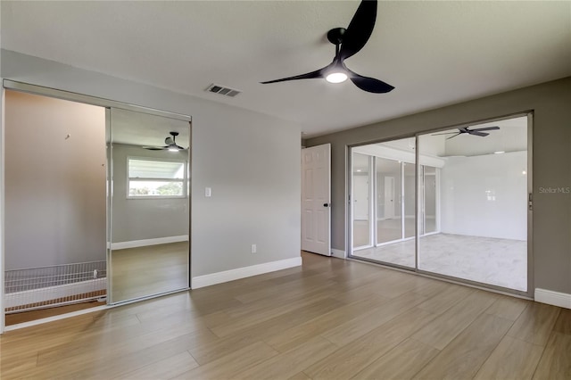 10744 Drummond Rd, Tampa, FL 33615 - unfurnished bedroom featuring wood finished floors, baseboards, ceiling fan, and a closet