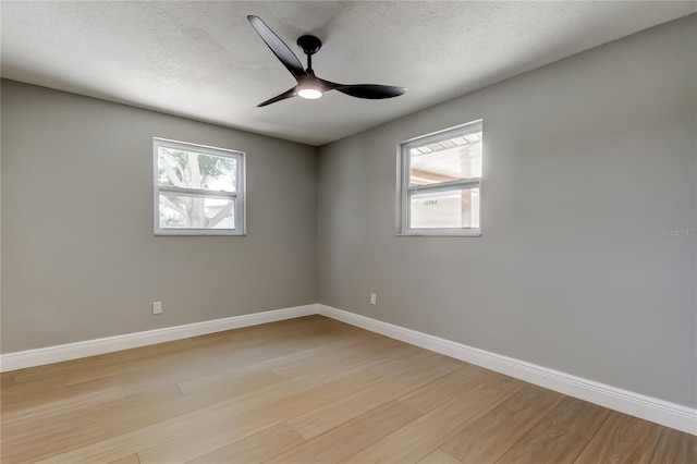 10744 Drummond Rd, Tampa, FL 33615 - unfurnished room featuring light wood finished floors, ceiling fan, baseboards, and a textured ceiling