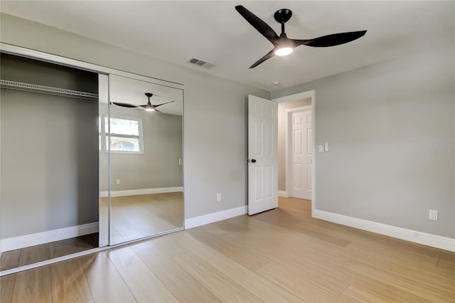 10744 Drummond Rd, Tampa, FL 33615 - unfurnished bedroom featuring light wood-type flooring, a closet, ceiling fan, and baseboards