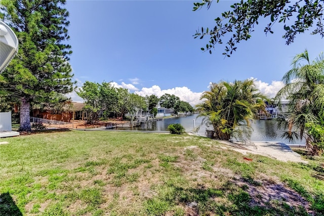 10744 Drummond Rd, Tampa, FL 33615 - view of grassy yard with a water view and a boat dock