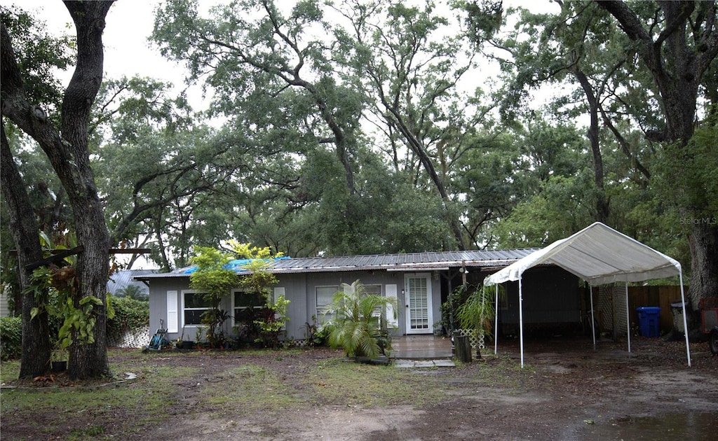 10514 Saint Rose Ct, Riverview, FL 33578 - single story home featuring a carport, metal roof, and dirt driveway