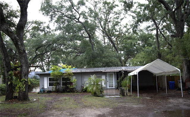 10514 Saint Rose Ct, Riverview, FL 33578 - single story home featuring a carport, metal roof, and dirt driveway