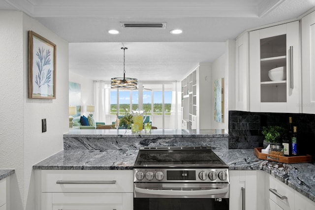 17920 Gulf Blvd Unit 1806, Redington Shores, FL 33708 - kitchen with electric stove, white cabinets, dark stone countertops, glass insert cabinets, and a textured wall