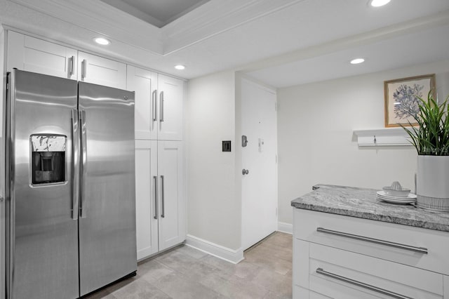 17920 Gulf Blvd Unit 1806, Redington Shores, FL 33708 - kitchen with stainless steel refrigerator with ice dispenser, recessed lighting, white cabinets, light stone counters, and baseboards