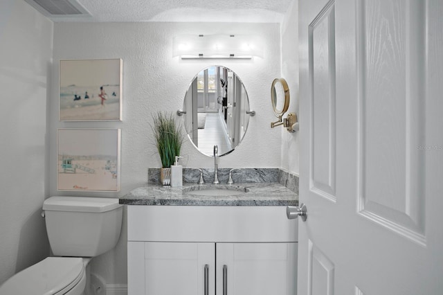 17920 Gulf Blvd Unit 1806, Redington Shores, FL 33708 - half bath with toilet, vanity, a textured ceiling, and a textured wall