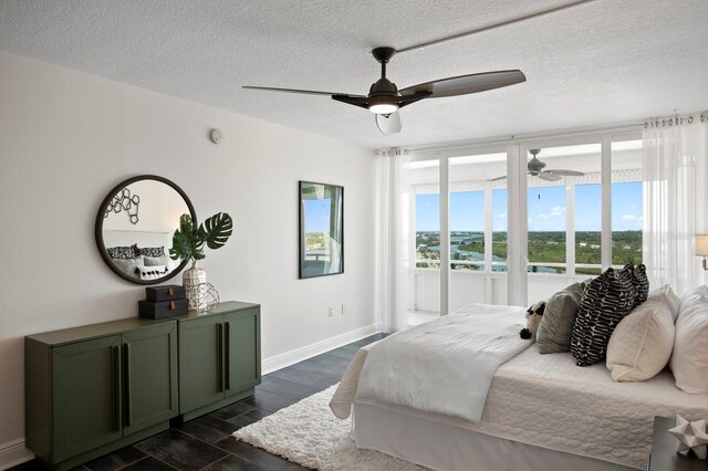 17920 Gulf Blvd Unit 1806, Redington Shores, FL 33708 - bedroom featuring dark wood-style floors, baseboards, a ceiling fan, and a textured ceiling