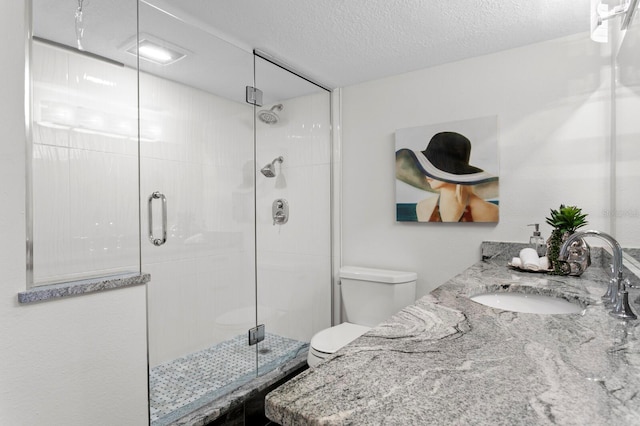 17920 Gulf Blvd Unit 1806, Redington Shores, FL 33708 - full bath featuring toilet, a shower stall, a textured ceiling, and double vanity
