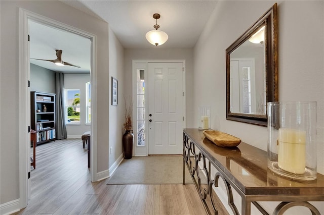 12957 Satin Lily Dr, Riverview, FL 33579 - foyer featuring light wood finished floors, baseboards, and a ceiling fan