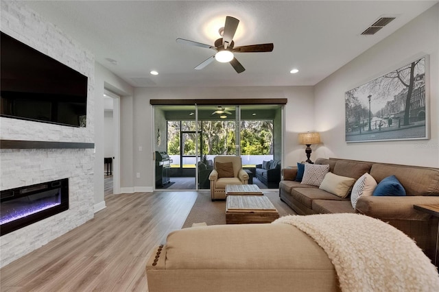 12957 Satin Lily Dr, Riverview, FL 33579 - living area with ceiling fan, wood finished floors, a fireplace, baseboards, and recessed lighting
