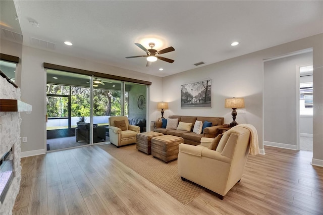 12957 Satin Lily Dr, Riverview, FL 33579 - living area with a fireplace, ceiling fan, light wood-type flooring, baseboards, and recessed lighting