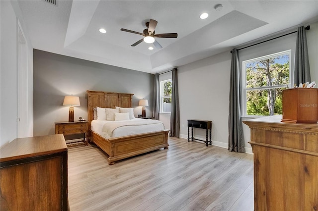 12957 Satin Lily Dr, Riverview, FL 33579 - bedroom with a tray ceiling, multiple windows, light wood-type flooring, recessed lighting, and baseboards