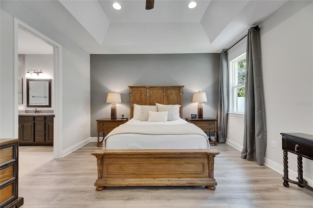 12957 Satin Lily Dr, Riverview, FL 33579 - bedroom with a raised ceiling, light wood-style flooring, ensuite bath, baseboards, and recessed lighting