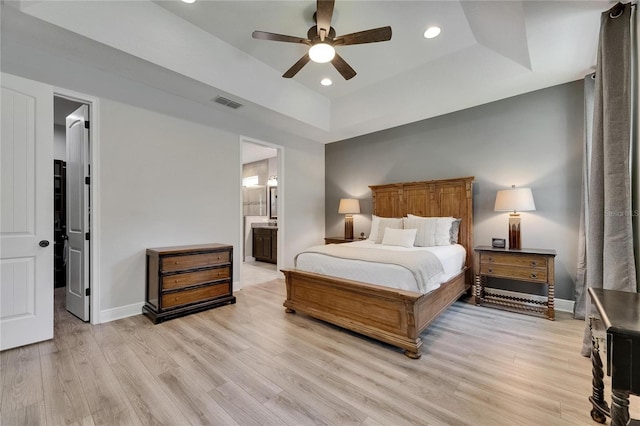12957 Satin Lily Dr, Riverview, FL 33579 - bedroom featuring a tray ceiling, a walk in closet, light wood-style flooring, baseboards, and recessed lighting