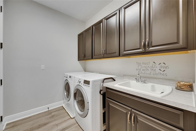 12957 Satin Lily Dr, Riverview, FL 33579 - washroom with cabinet space, independent washer and dryer, light wood-style floors, and baseboards