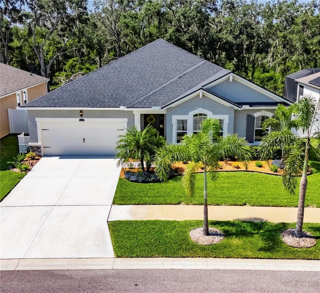12957 Satin Lily Dr, Riverview, FL 33579 - ranch-style home featuring a shingled roof, an attached garage, driveway, and a front yard