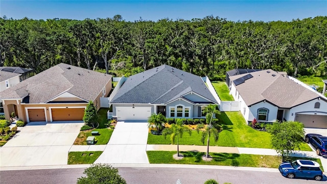 12957 Satin Lily Dr, Riverview, FL 33579 - aerial view of residential area with a forest