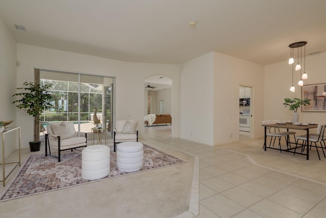 987 Chickadee Dr, Venice, FL 34285 - living room featuring light tile patterned flooring and arched walkways