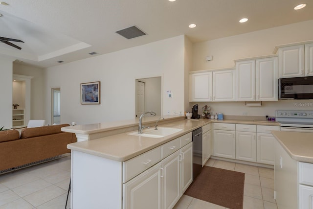 987 Chickadee Dr, Venice, FL 34285 - kitchen with black microwave, a sink, electric stove, light tile patterned flooring, and light countertops