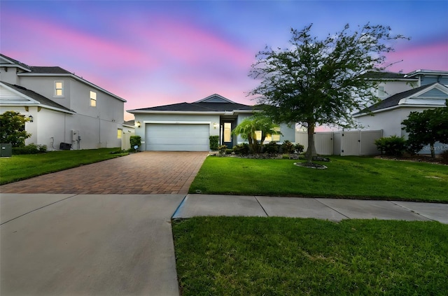 751 Cajeput Loop, Tarpon Springs, FL 34689 - ranch-style home with decorative driveway, an attached garage, a gate, and stucco siding