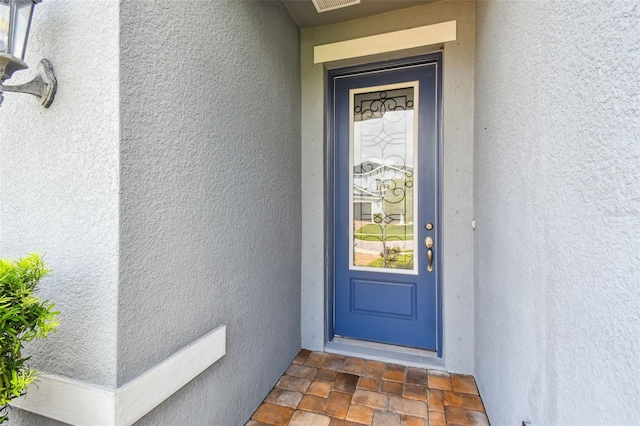 751 Cajeput Loop, Tarpon Springs, FL 34689 - view of exterior entry featuring stucco siding