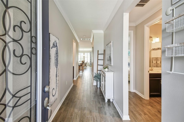 751 Cajeput Loop, Tarpon Springs, FL 34689 - entrance foyer with wood finished floors, crown molding, and baseboards