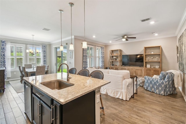 751 Cajeput Loop, Tarpon Springs, FL 34689 - kitchen featuring a sink, a chandelier, stainless steel dishwasher, plenty of natural light, and ornamental molding