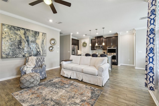 751 Cajeput Loop, Tarpon Springs, FL 34689 - living room with a ceiling fan, recessed lighting, crown molding, baseboards, and light wood-style floors