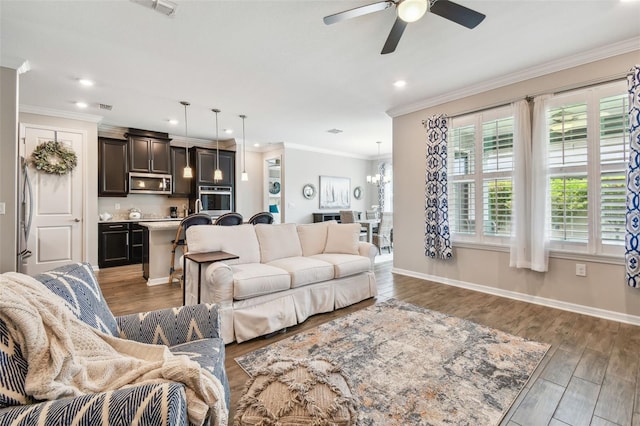 751 Cajeput Loop, Tarpon Springs, FL 34689 - living area featuring recessed lighting, ceiling fan, wood finished floors, ornamental molding, and baseboards