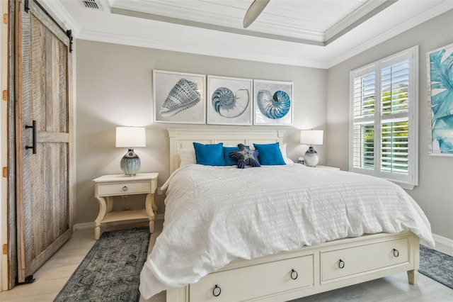 751 Cajeput Loop, Tarpon Springs, FL 34689 - bedroom with a tray ceiling, a barn door, crown molding, baseboards, and a ceiling fan