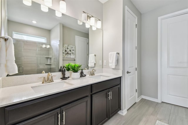 751 Cajeput Loop, Tarpon Springs, FL 34689 - bathroom featuring double vanity, a shower stall, and baseboards