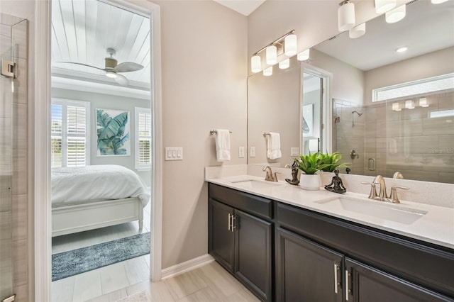 751 Cajeput Loop, Tarpon Springs, FL 34689 - ensuite bathroom with double vanity, a stall shower, a ceiling fan, and baseboards