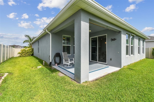 751 Cajeput Loop, Tarpon Springs, FL 34689 - back of house featuring stucco siding and a patio area